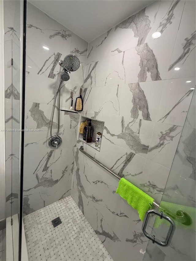 bathroom with a shower with door