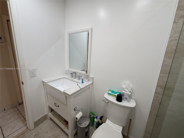 bathroom with vanity, toilet, and tile patterned flooring