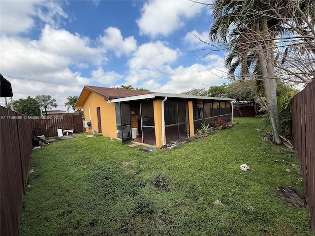 exterior space with a yard and a sunroom