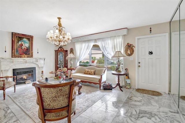 living room featuring a premium fireplace, marble finish floor, and an inviting chandelier