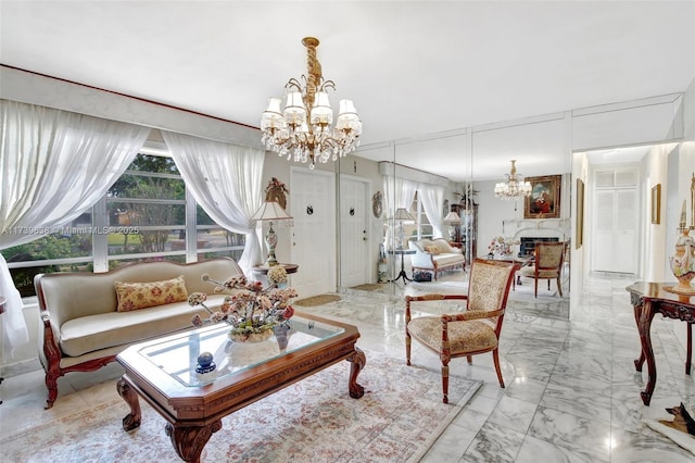 living area featuring marble finish floor, an inviting chandelier, and a wealth of natural light