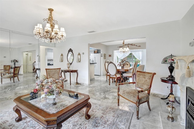 living room featuring visible vents, marble finish floor, and a chandelier