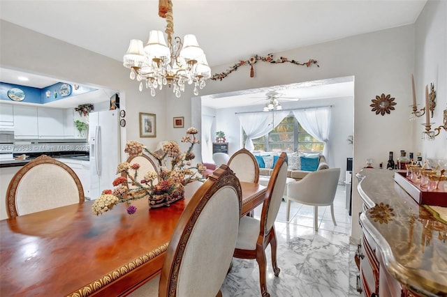 dining room with marble finish floor and ceiling fan with notable chandelier