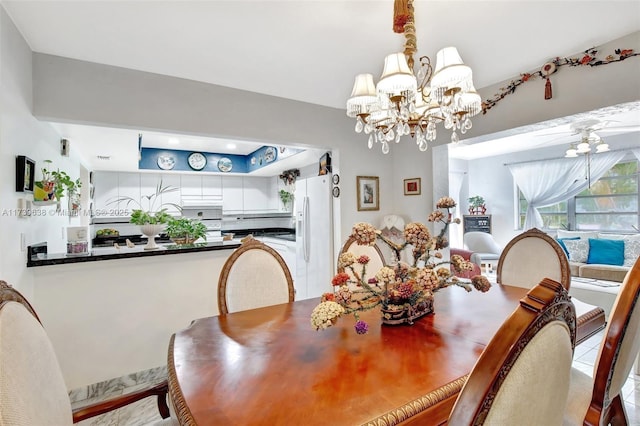 dining space featuring an inviting chandelier and a raised ceiling
