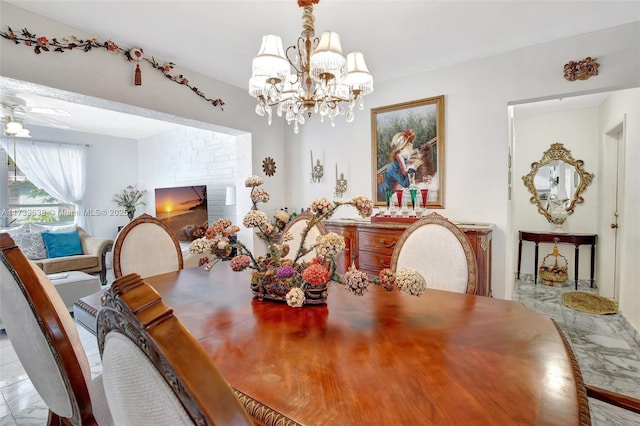 dining space featuring ceiling fan with notable chandelier