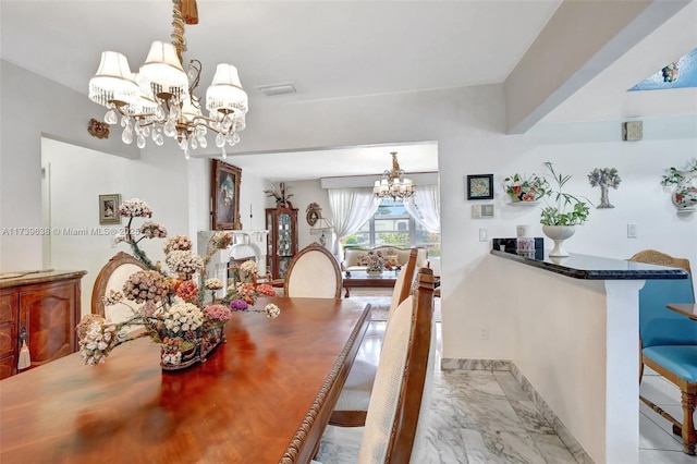 dining area featuring visible vents, marble finish floor, baseboards, and a notable chandelier