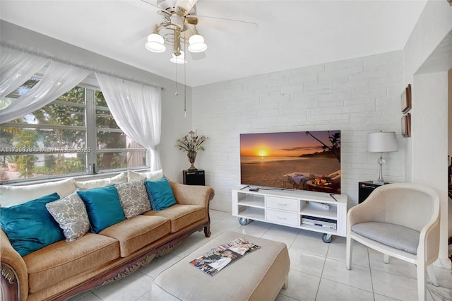 living area with tile patterned flooring and a ceiling fan