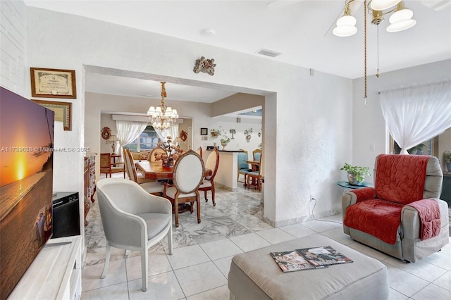 living room with visible vents and a notable chandelier