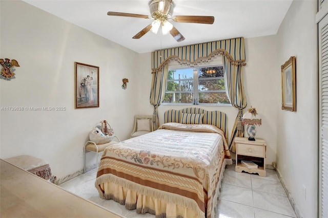 bedroom featuring light tile patterned floors and ceiling fan