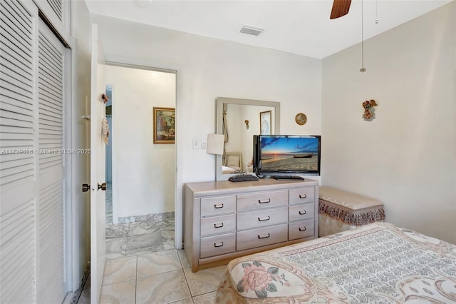 bedroom featuring a closet, visible vents, marble finish floor, and ceiling fan