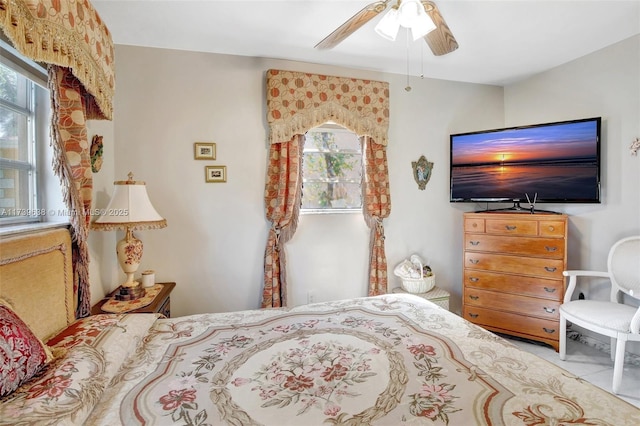 bedroom featuring ceiling fan and multiple windows