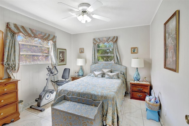 bedroom featuring a ceiling fan, crown molding, and light tile patterned flooring