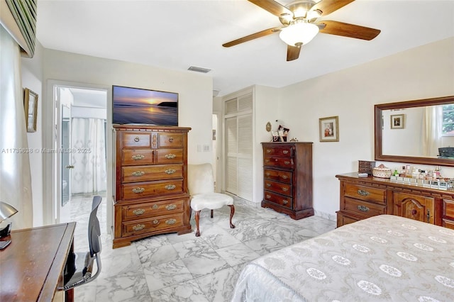 bedroom with marble finish floor, ceiling fan, visible vents, and a closet
