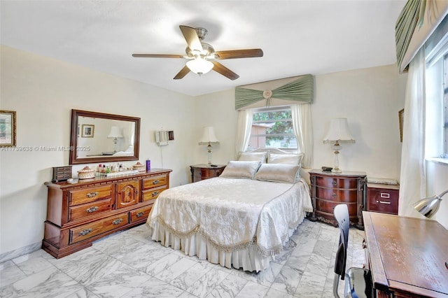 bedroom with marble finish floor and ceiling fan