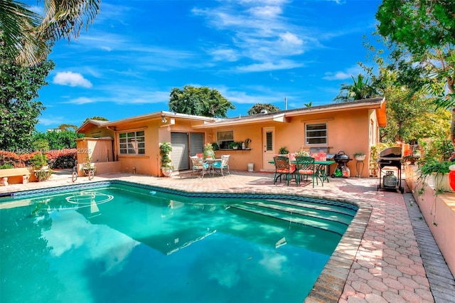 view of swimming pool with a fenced in pool, fence, a patio area, area for grilling, and outdoor dining area