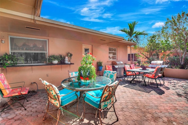 view of patio featuring grilling area and outdoor dining space