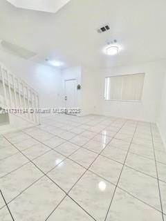 spare room featuring light tile patterned flooring