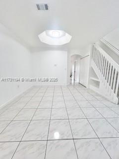 unfurnished room with light tile patterned floors