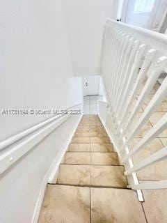 stairs with tile patterned floors