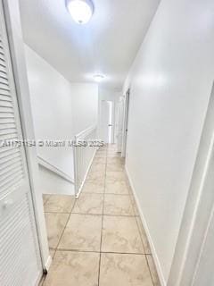 hall featuring tile patterned flooring