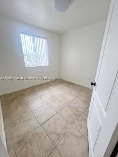 empty room featuring light tile patterned floors