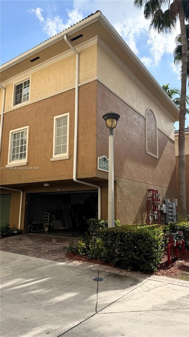 view of side of home with a garage