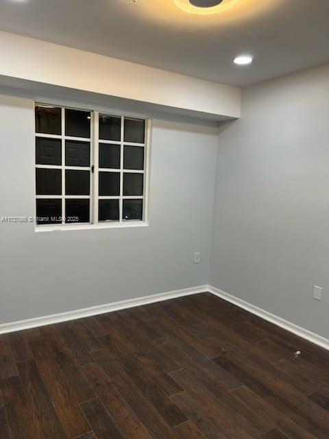 unfurnished room with dark hardwood / wood-style floors