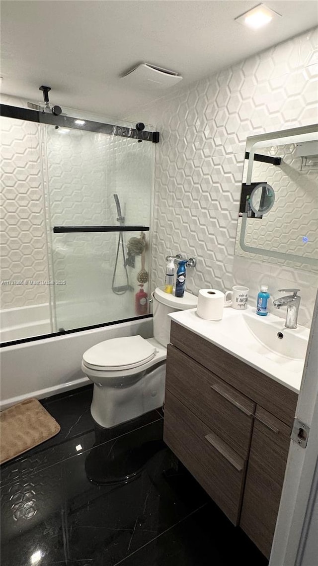 full bathroom with toilet, tasteful backsplash, bath / shower combo with glass door, tile walls, and vanity