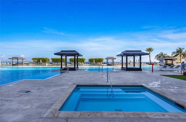 view of pool featuring a gazebo, a hot tub, and a patio