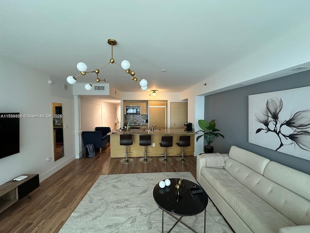 living room with dark hardwood / wood-style flooring and sink