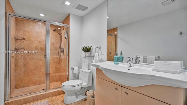 bathroom featuring vanity, toilet, a shower with shower door, and tile patterned flooring