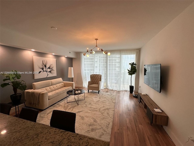 living room featuring hardwood / wood-style flooring and a chandelier