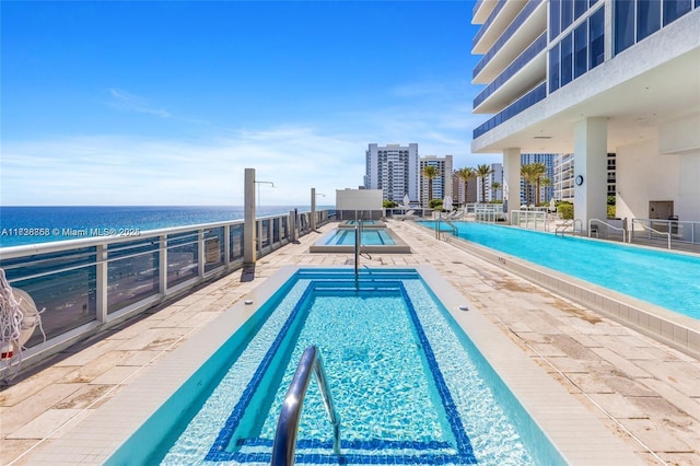 view of pool with a water view