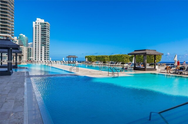 view of swimming pool with a gazebo and a patio area