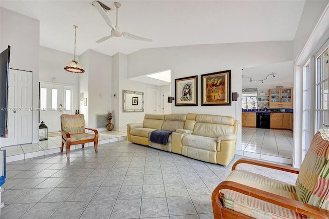 living room with plenty of natural light, light tile patterned floors, and high vaulted ceiling