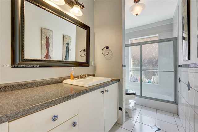 bathroom with tile patterned flooring, vanity, walk in shower, toilet, and a bidet