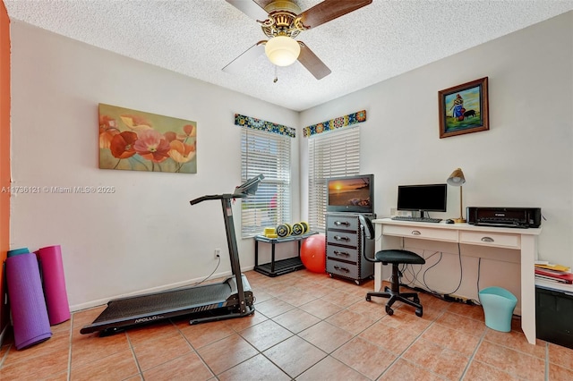 tiled home office with ceiling fan and a textured ceiling