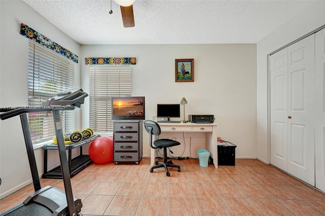 office area featuring light tile patterned flooring, ceiling fan, and a textured ceiling