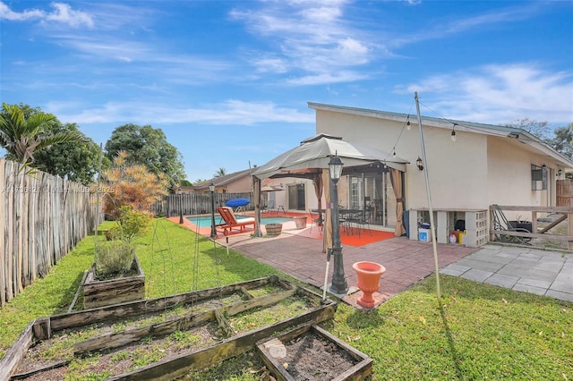 rear view of house with a yard, a lanai, a fenced in pool, and a patio