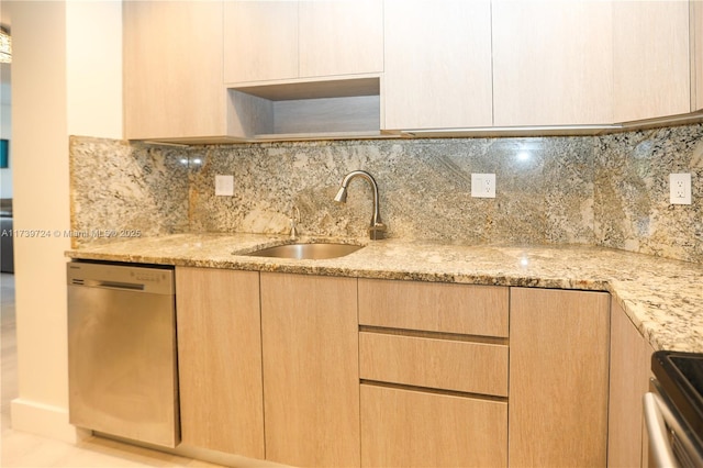 kitchen with light stone counters, sink, dishwasher, and light brown cabinets