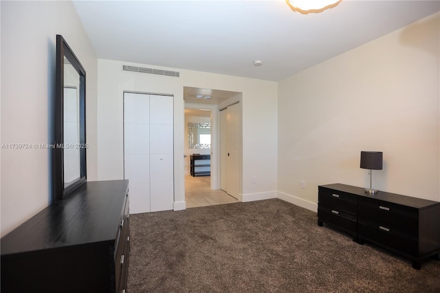 bedroom featuring light carpet and a closet