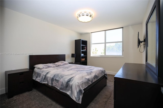 bedroom with dark colored carpet