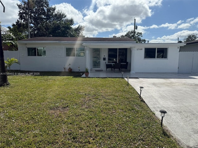 rear view of house featuring covered porch and a lawn