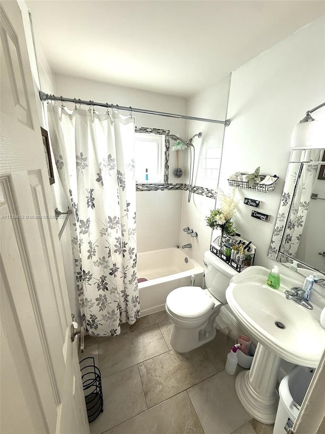 full bathroom featuring sink, shower / tub combo with curtain, tile patterned floors, and toilet