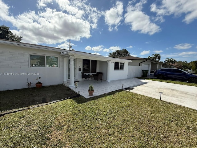 view of front of home featuring a patio area and a front lawn