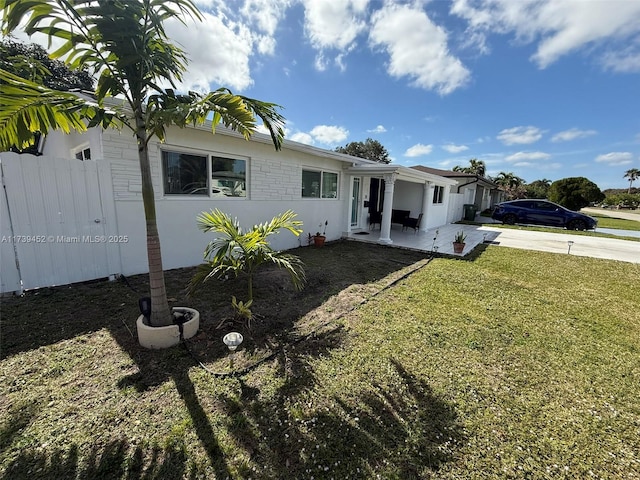 view of front facade with a patio and a front lawn