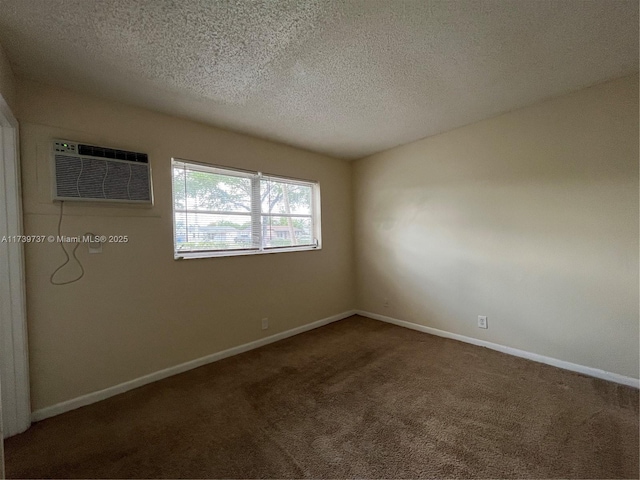 unfurnished room featuring carpet flooring, a wall mounted air conditioner, and a textured ceiling