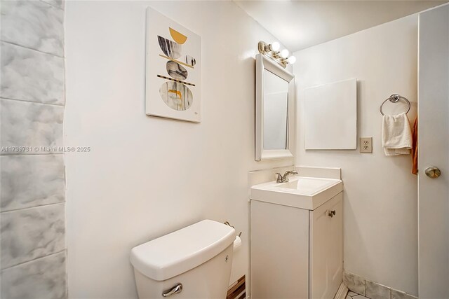 bathroom featuring vanity and toilet