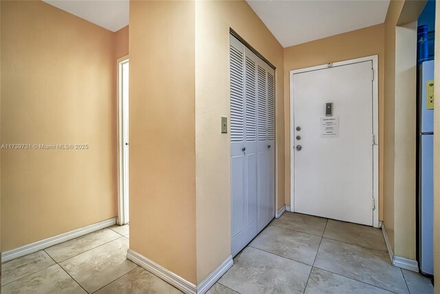 hallway with light tile patterned flooring