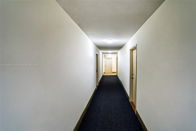 hallway with a textured ceiling